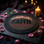 Embroidered rope placemat with Faith Over Fear design, styled on dark moody slate with rose petals and candlelight